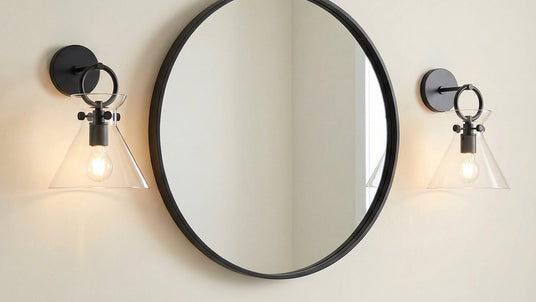 Aris wall sconc with clear glass and matte black finishes