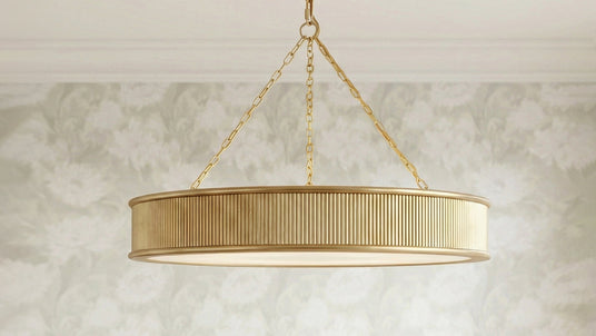 Bishop Ring Chandelier 36", Gilded Brass finish shown ina. bright dining room with sage green floral wallapper