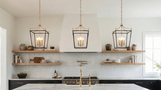 Three Cambria pendants in black and brass hung in a kitchen with floating shelves in the background and black cabinetry.