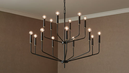 Two tier Black chandelier with brass details and exposed candelabra bulbs