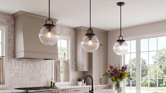 The Whitaker Collection features clear reeded glass globes and versatile finishes bringing vintage-inspired style to ceiling lights, pendants, vanity lights, kitchens, bathrooms, bedrooms, and entryways.
