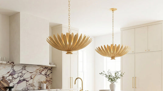 Two Yasmin Pendants in gold leaf finish hung in a modern luxe kitchen