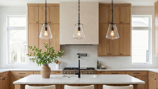Three Small Addison Pendant Lights in Matte Black with clear glass in a transitional kitchen.