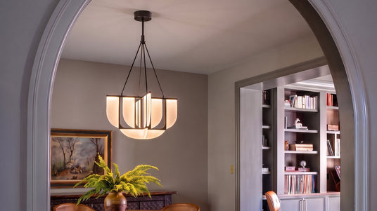 Dagan LED Modern 30" Chandelier in Urban Bronze and 3000K light hung in a dining room with arched entry.