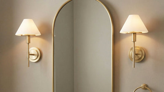 Two Dean Wall Sconces, in Satin Brass and Opal Glass in a neutral powder room.