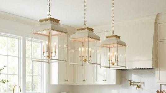 Open Frame Lantern Style Pendants in Matte Black are hung in a lareg room with white walls and wooden exposed beams.