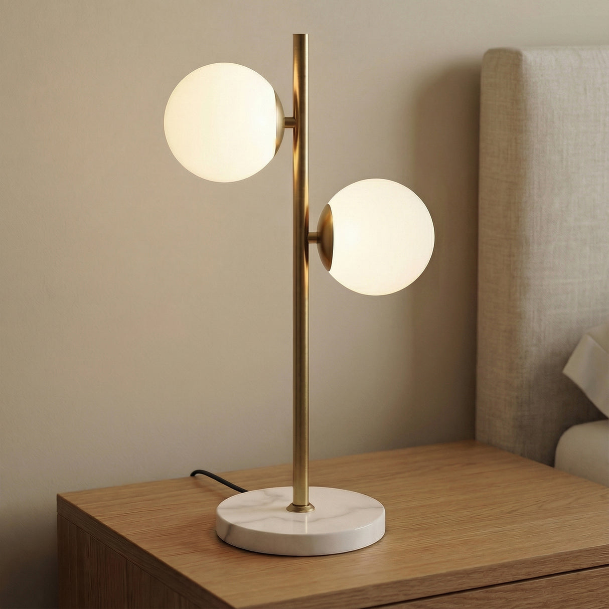 Castell 2 Globe Table Lamp, Aged Brass styled in a Modern Bedroom with a marble base and wooden nightstand.