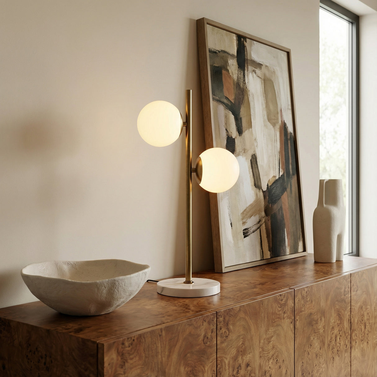 Castell 2 Globe Table Lamp, Aged Brass globe Table Lamp in a Modern Living Room with a burl wood credenza.