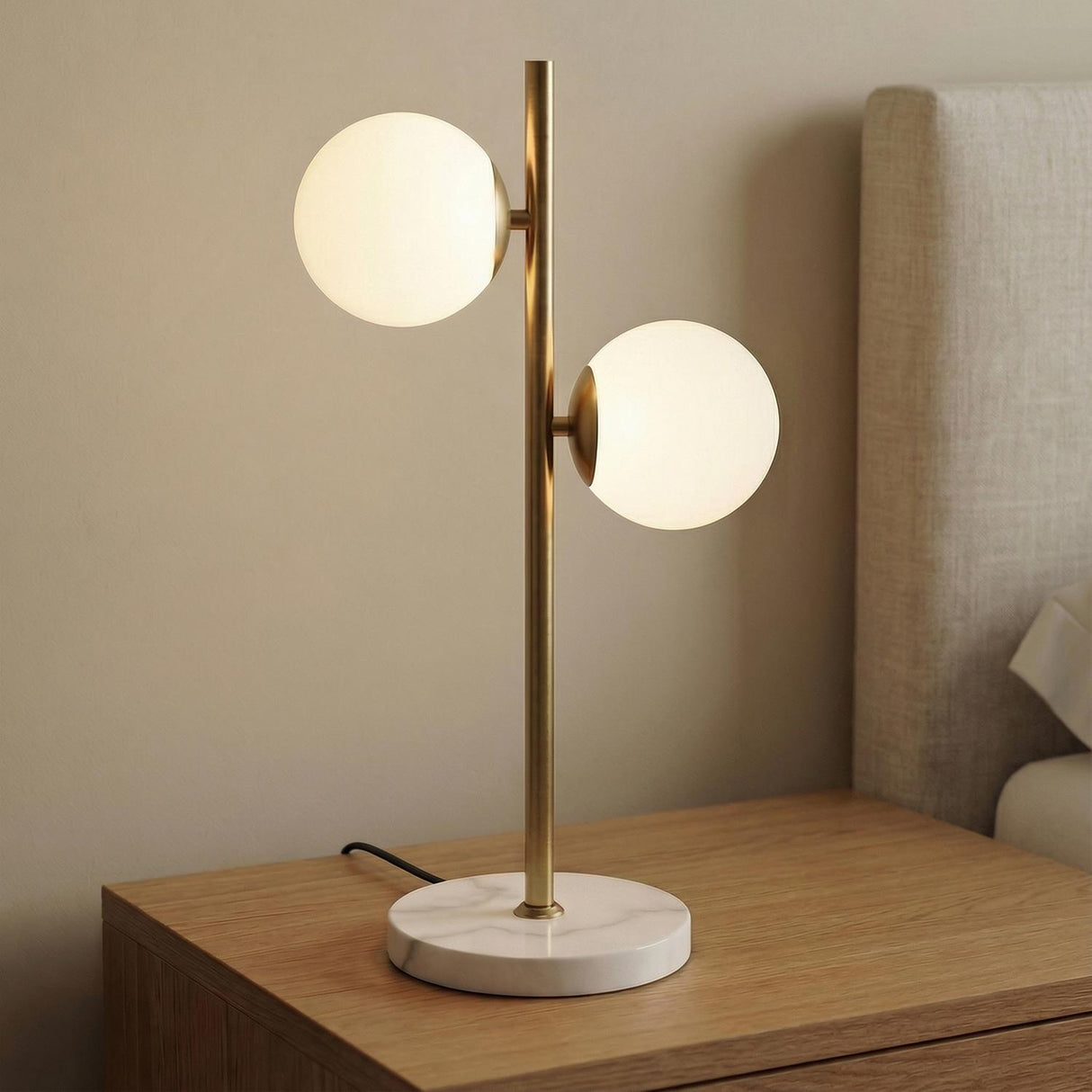 Castell 2 Globe Table Lamp, Aged Brass styled in a Modern Bedroom with a marble base and wooden nightstand.