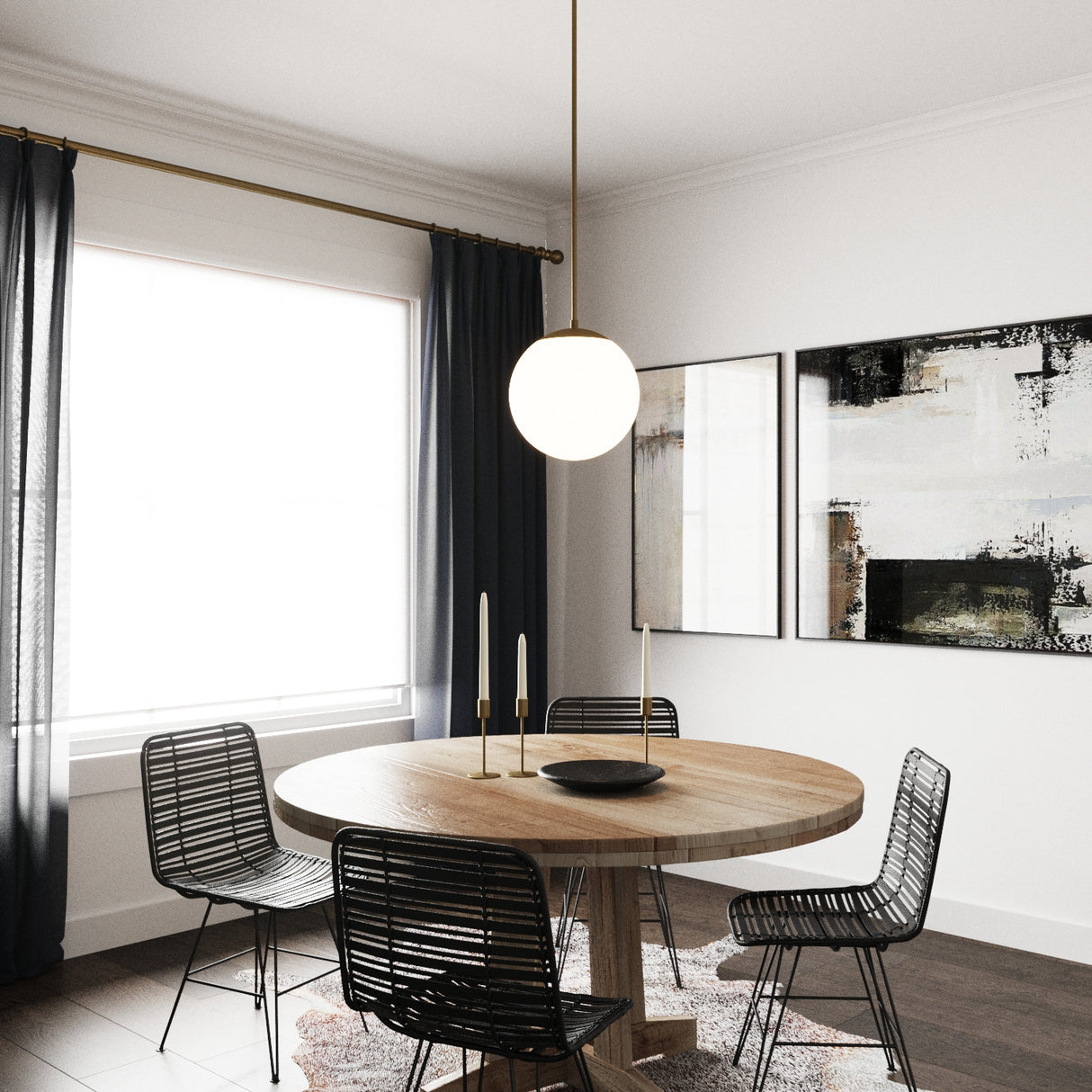 Single Castell 12" LED Pendant Light in Aged Brass hung above a round wooden dining table with four black modern chairs and dark curtain and art