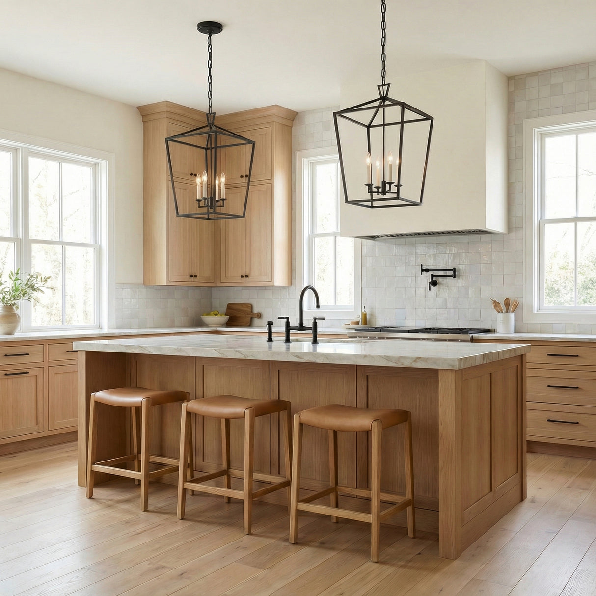 Anover Large Lantern Pendant 17", Matte Black geometric pendant in a Modern Farmhouse Kitchen with a white marble island and wood stools.