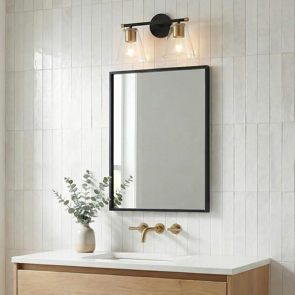Carlisle 2 Light Vanity, Matte Black and Brushed Brass with Clear Glass geometric vanity light in a Modern Bathroom with white subway tile.