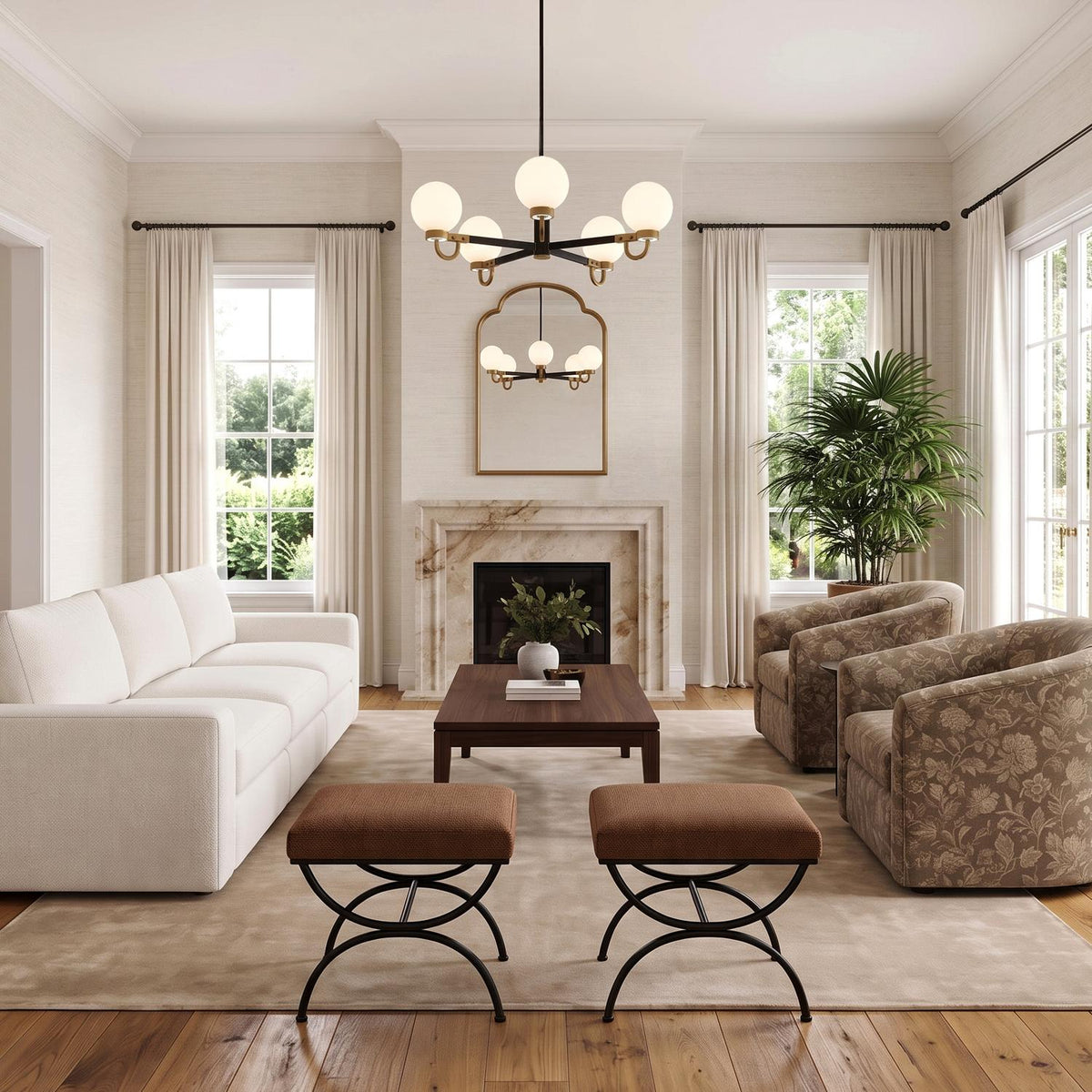 A transitional living room features the Ryan 5 Light Chandelier 30 in Matte Black and Aged Brass hung above a dark wood coffee table and marble fireplace.