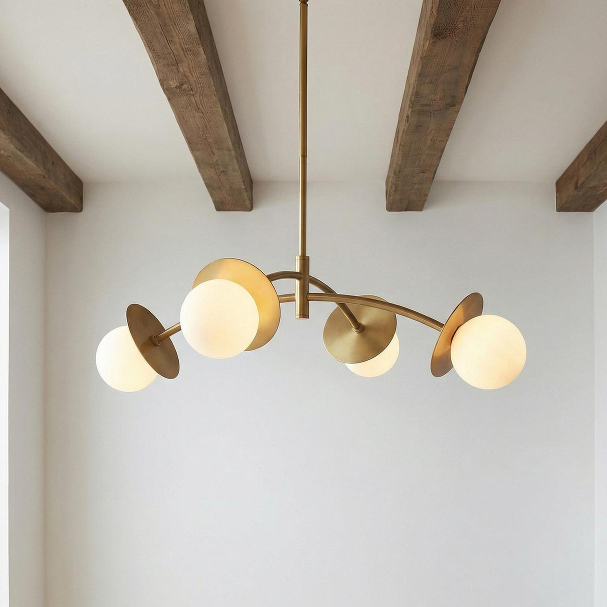 Levi 4 Globe Chandelier 26", Aged Brass globe Chandelier in a Modern Farmhouse Living Room with exposed wood beams.