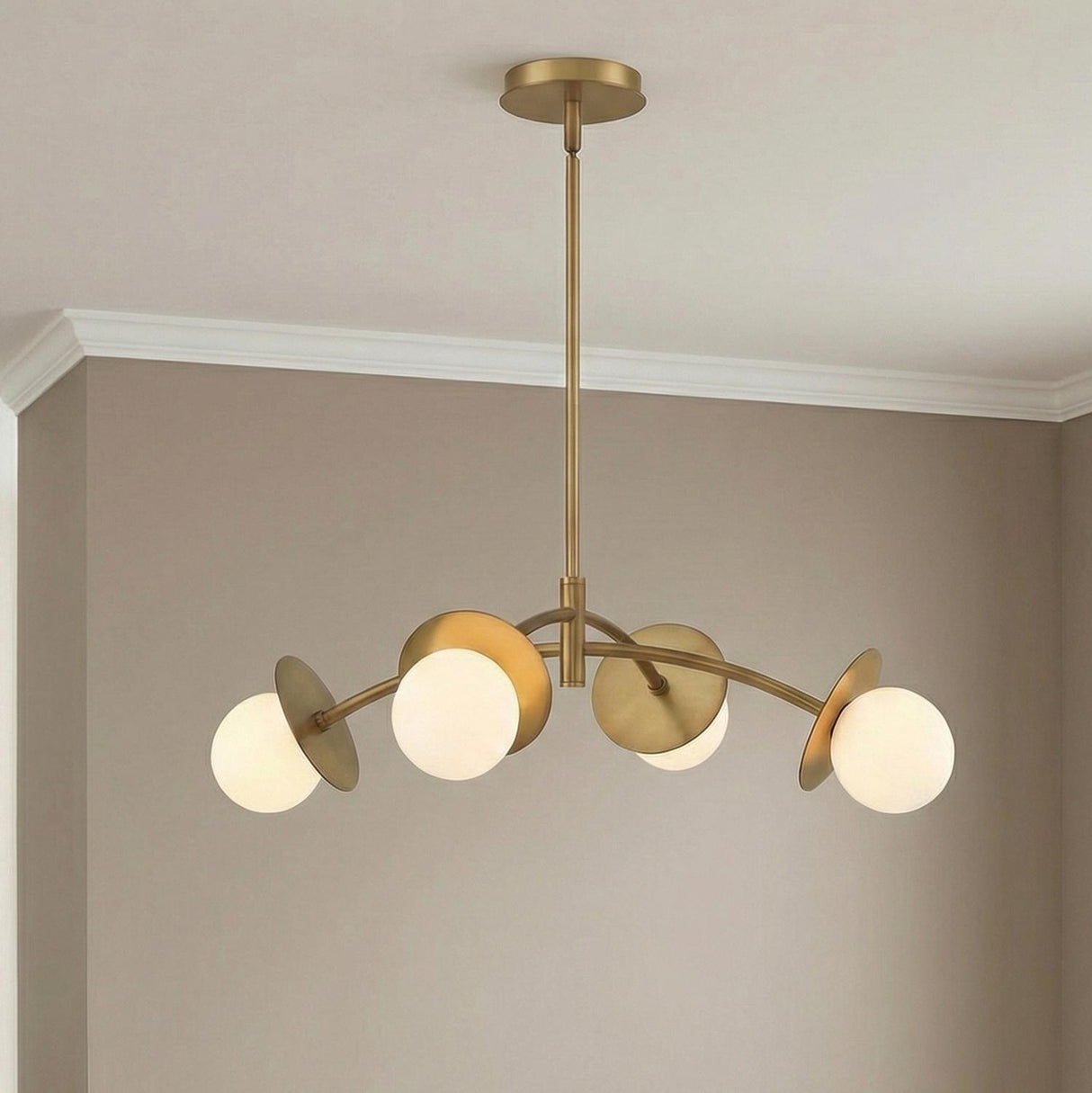 Levi 4 Globe Chandelier, Aged Brass globe Chandelier in a Contemporary Dining Room with taupe walls and white crown molding.