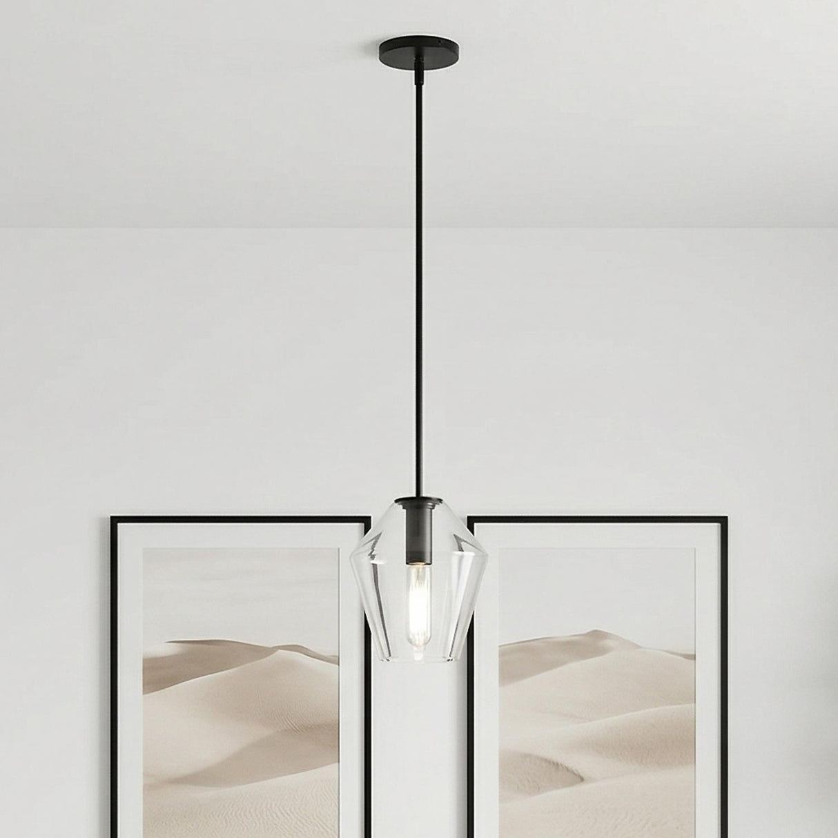 Eva 9" Clear Diamond Pendant, Matte Black geometric Pendant in a Modern Living Room with desert landscape framed art.