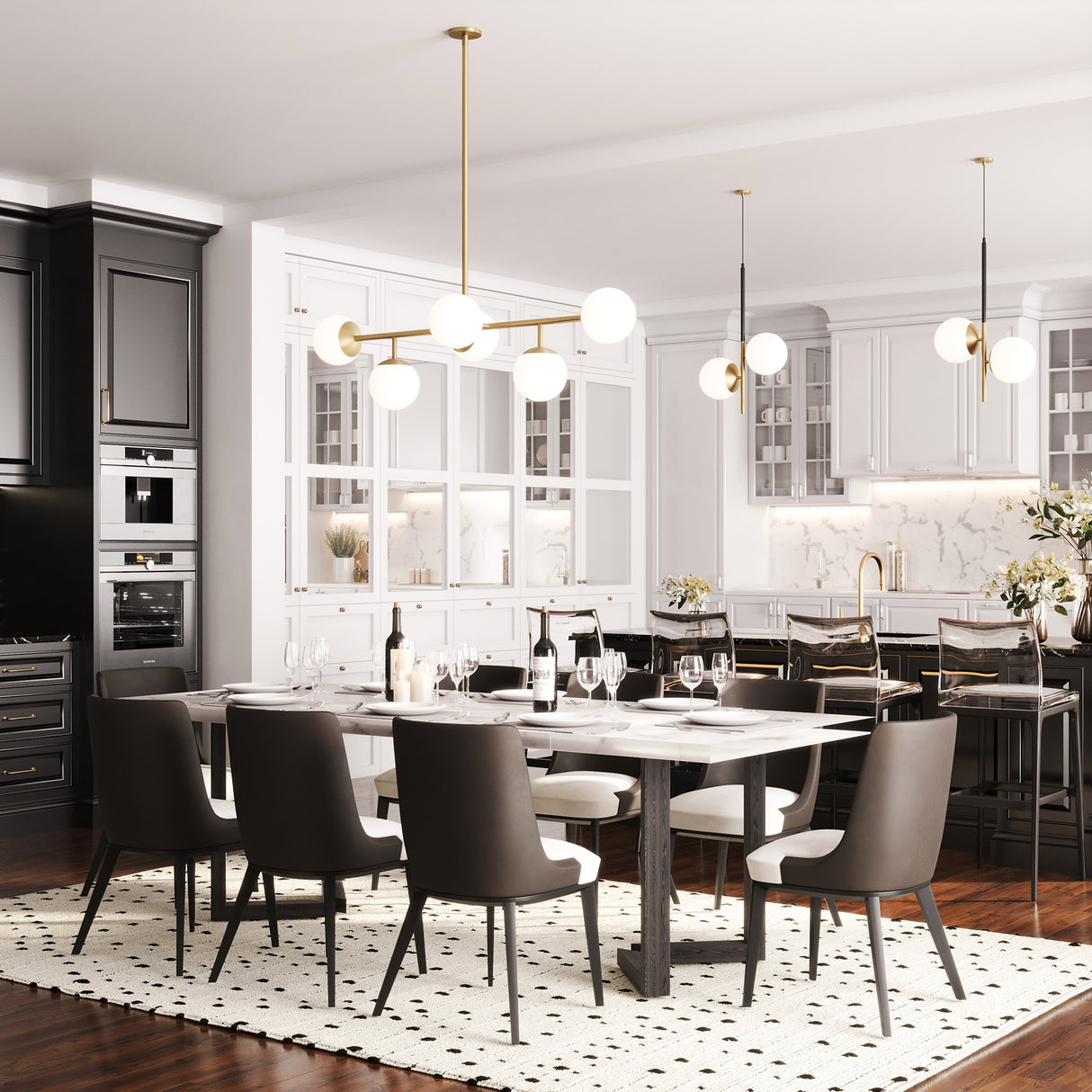 Castell 6 Globe Linear Mid-Century Modern LED Pendant in Aged Brass and two Castell 2 Globe Pendant Lights in Aged Brass and Black shown in an open concept contemporary kitchen and dining room. The pendant is hung over a long black and white table, while the pendants are hung over the black marble kitchen island.
