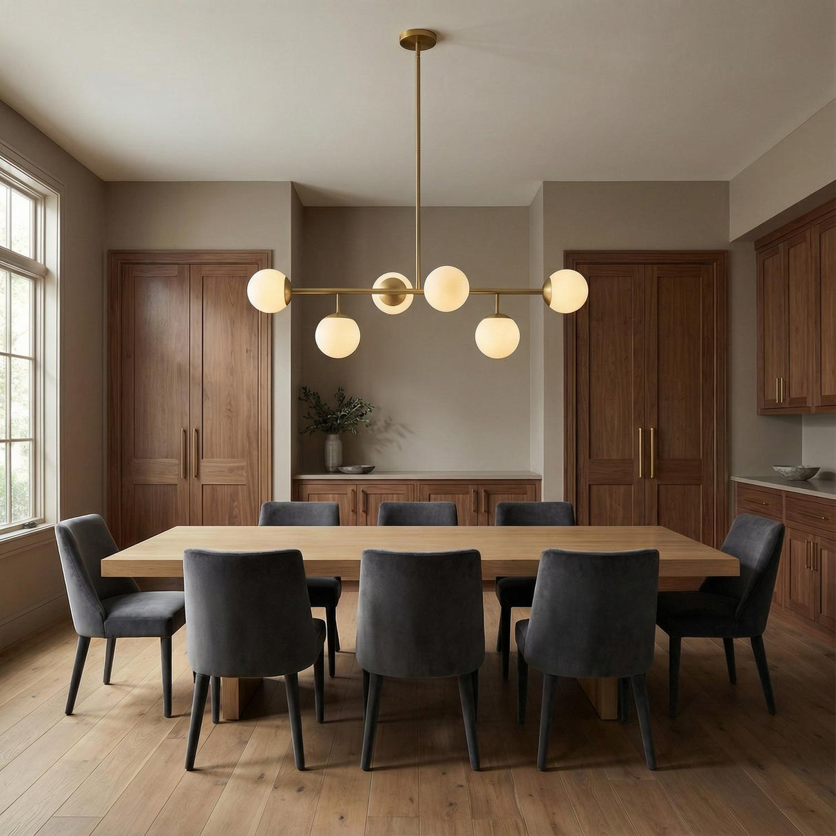 Castell 6 Globe Linear Pendant 46", Aged Brass globe linear pendant in a Modern Dining Room with an oak dining table.