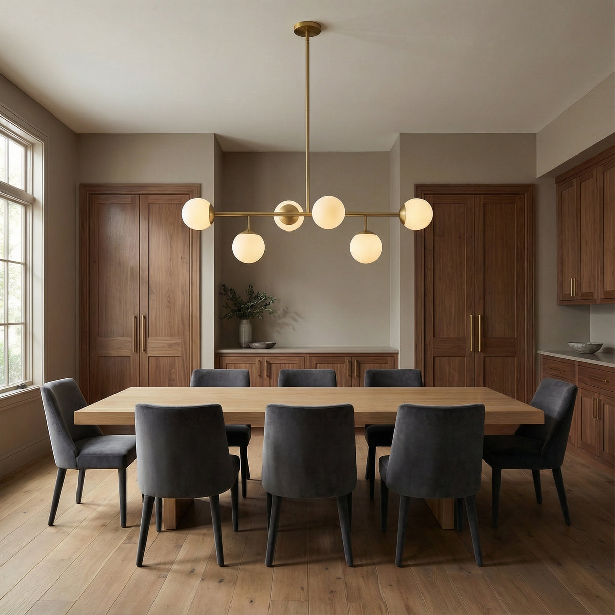 Castell 6 Globe Linear Pendant 46", Aged Brass globe linear pendant in a Modern Dining Room with an oak dining table.