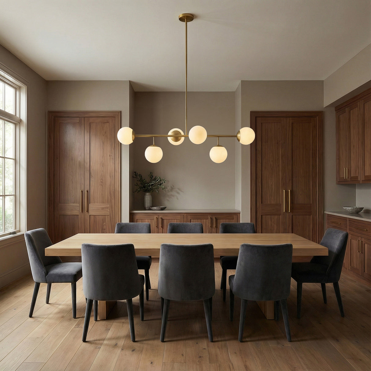 Castell 6 Globe Linear Pendant 46", Aged Brass globe linear pendant in a Modern Dining Room with an oak dining table.