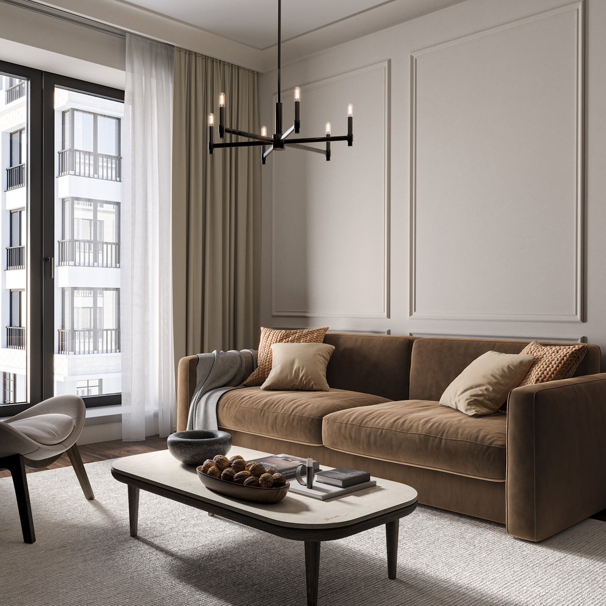 Carson 6 Light 26" Modern Matte Black Chandelier, shown in a transitional smaller living room with a mocha colored velvet sofa and modern chair