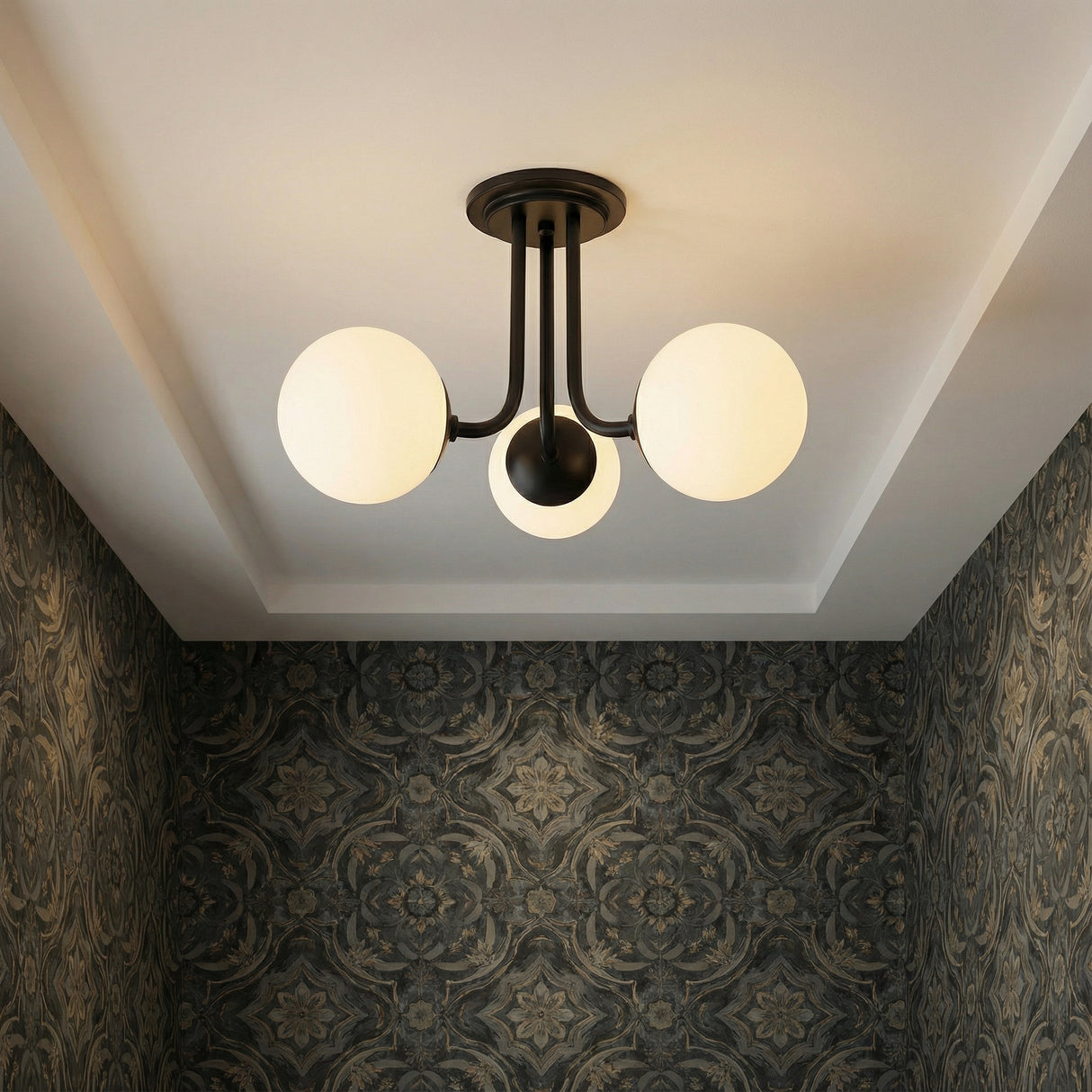 Matte Black globe semi-flush mount in a Transitional Living Room with ornate patterned wallpaper.