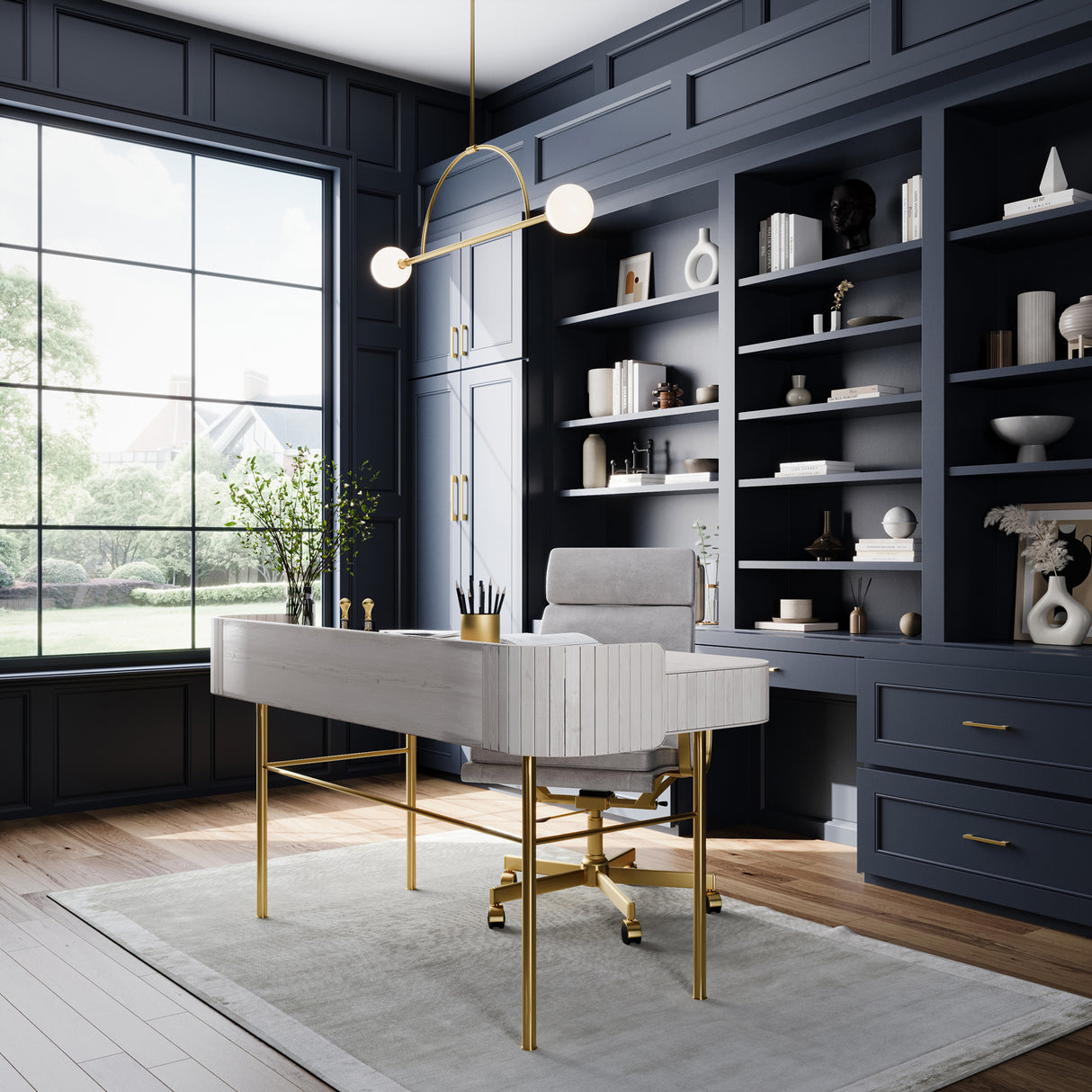 Milo 2 Globe Linear Arc LED Pendant, Aged Brass with white opal glass, shown in a deep blue painted home office, hung above a desk with brass legs