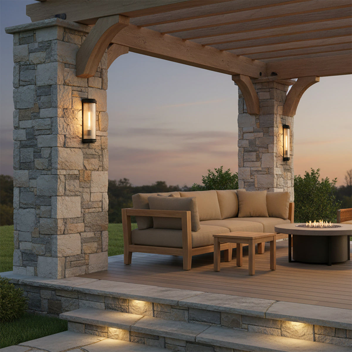 Bristol Outdoor Wall Light, Matte Black with Brass Accents - Outdoor patio with stone pillars, wooden pergola, sectional sofa, fire pit, and step lighting.