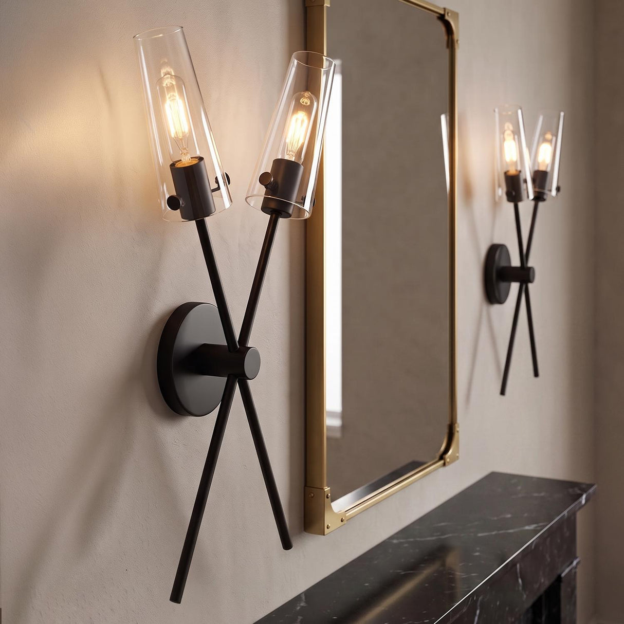 A contemporary living room with two matte black Mason 2 Light Wall Sconces with clear glass shades flanking a gold mirror above a black marble mantle.