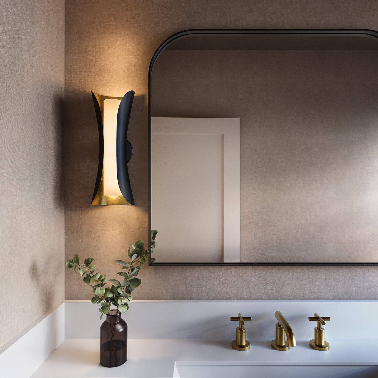 Rhys Wall Sconce, Matte Black Shade and Gold Leaf Interior with opal glass next to vanity mirror with taupe walls.