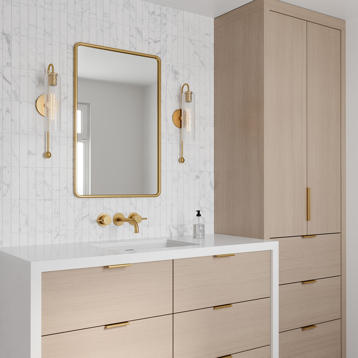 Dessie 19" Aged Brass Curved Arm Wall Sconce with Crackled Glass shown in aa modern bathroom, with a waterfall edge vanity, flanking a brass vanity mirror.