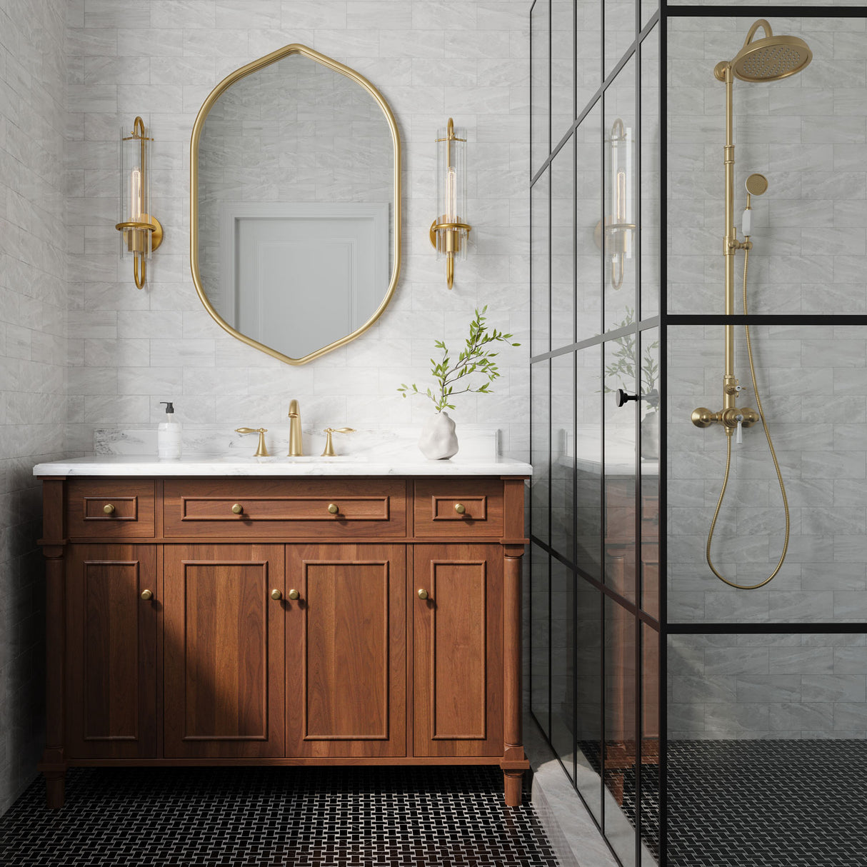Camie 20 inch tall art-deco wall sconce with reeded glass and aged brass finish in am updated vintage bathroom, flanking a brass vanity mirror with marble tiled walls.