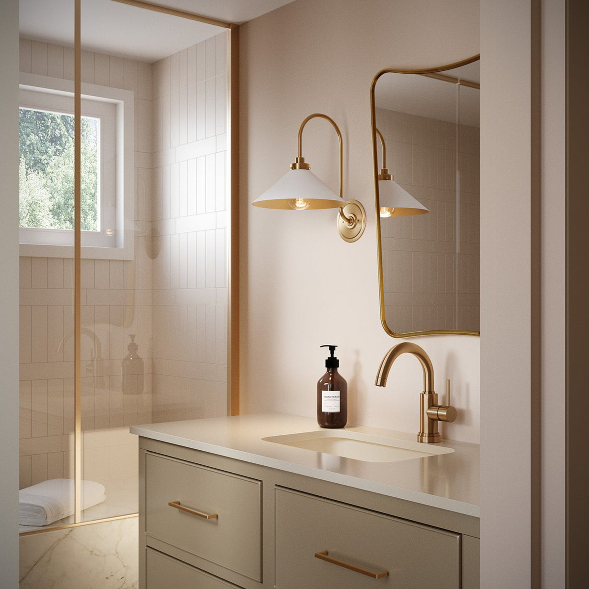 Alma white metal and brass gooseneck wall sconce shown in a bathroom with dusty pink walls and brass hardware.