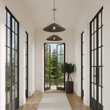 Two Zane Large 23" pendants in Graphite grey hung in a long white hallway with black metal frame doors on either side