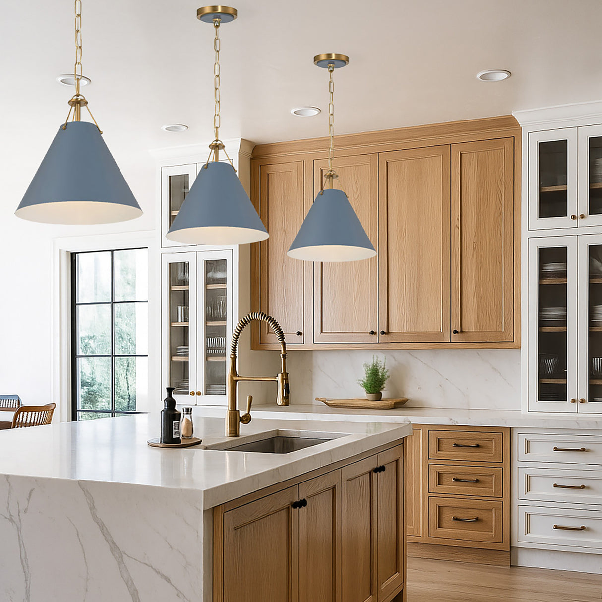 Three Bowie Small Metal Pendant 12", French Blue and Brass hung in a kitchen with white marble counters and white oak cabinets