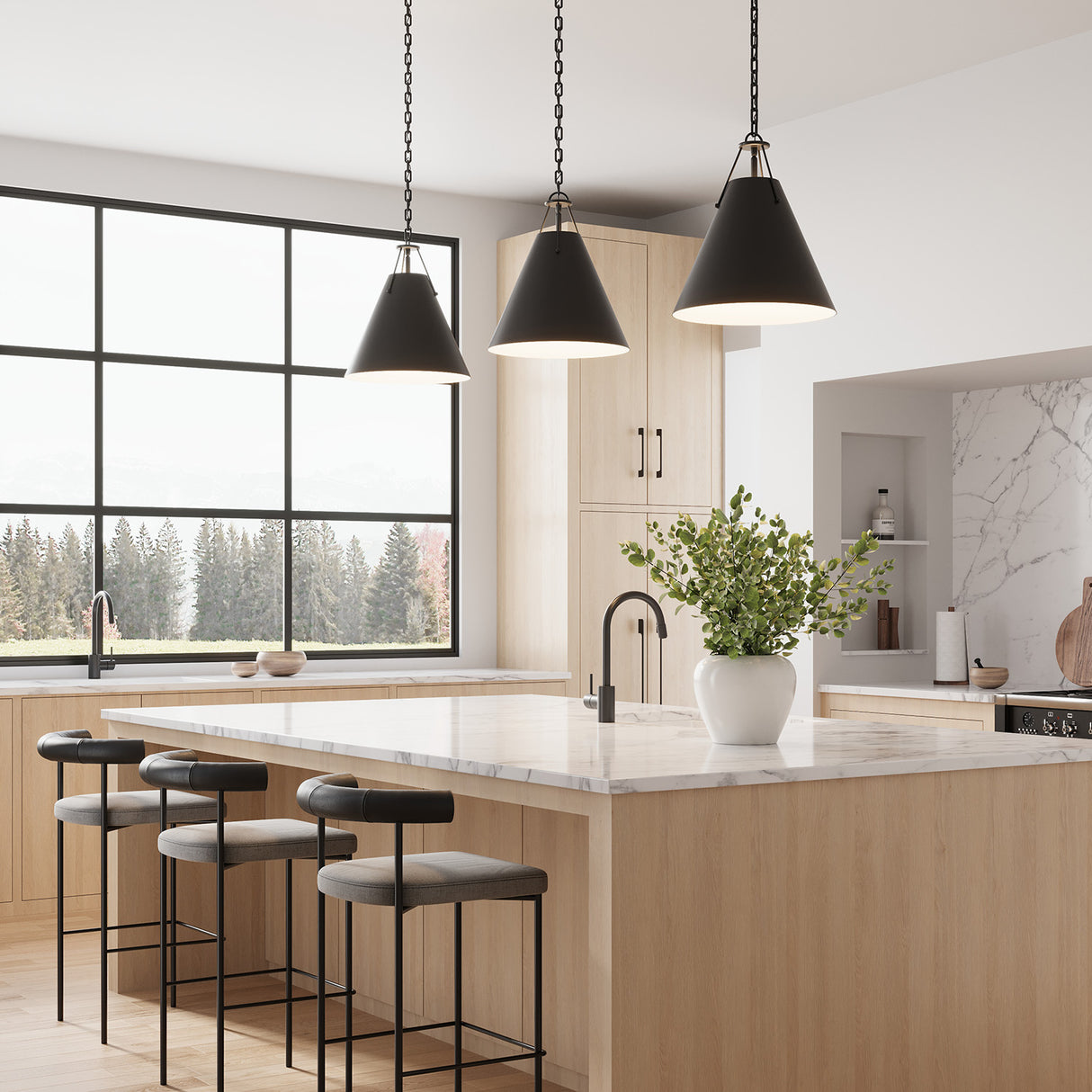 Three Bowie 16" Pendants in Black hung over a large kitchen island in a contemporary kitchen with a large black frame window.