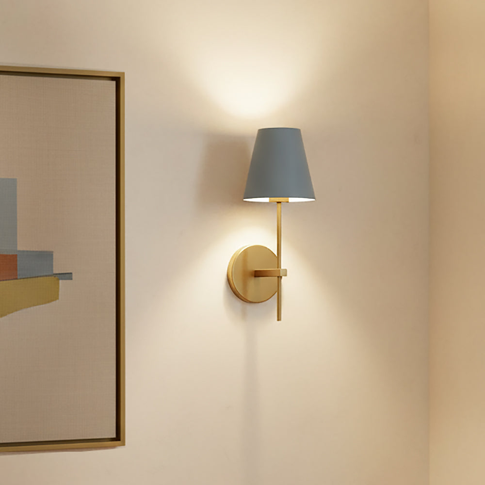 Banks Wall Sconce, French Blue and Brass shown on a beige wall next to modern art in a brass frame.