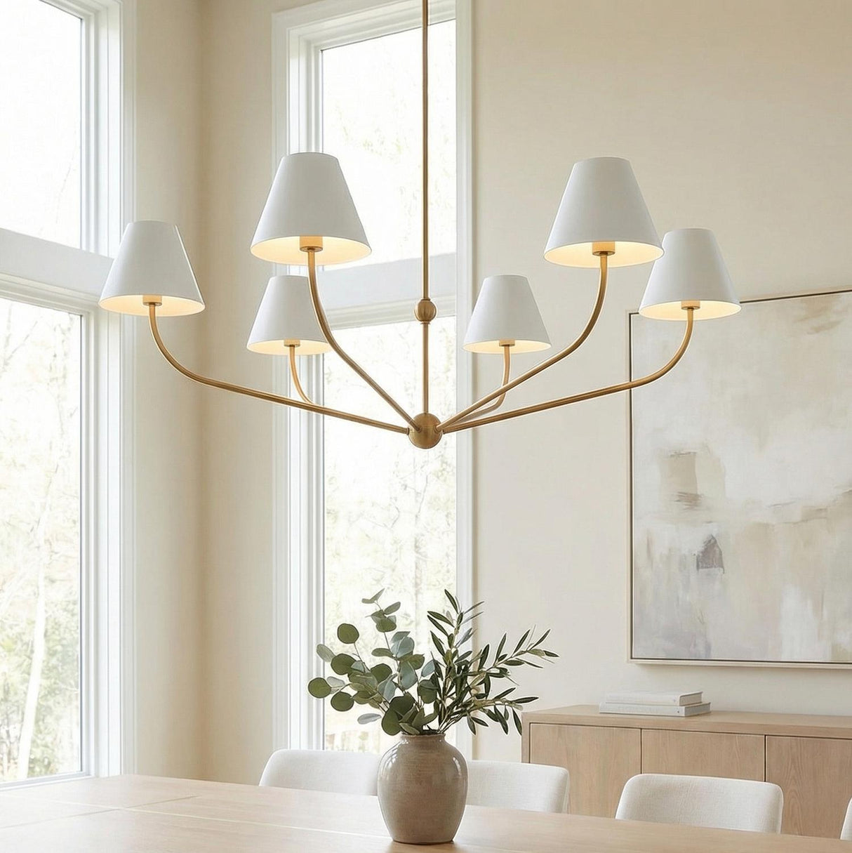 Banks 6 Light Chandelier 48", White and Brass Brass linear Chandelier in a Transitional Dining Room with a light wood table and abstract art.