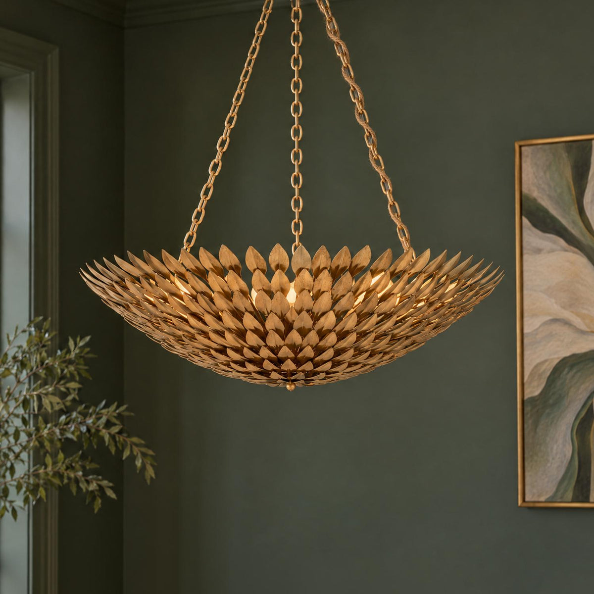 A transitional living room featuring the Alysa Pendant 30", Antique Gold with layered leaf detailing, set against dark green walls and framed artwork.