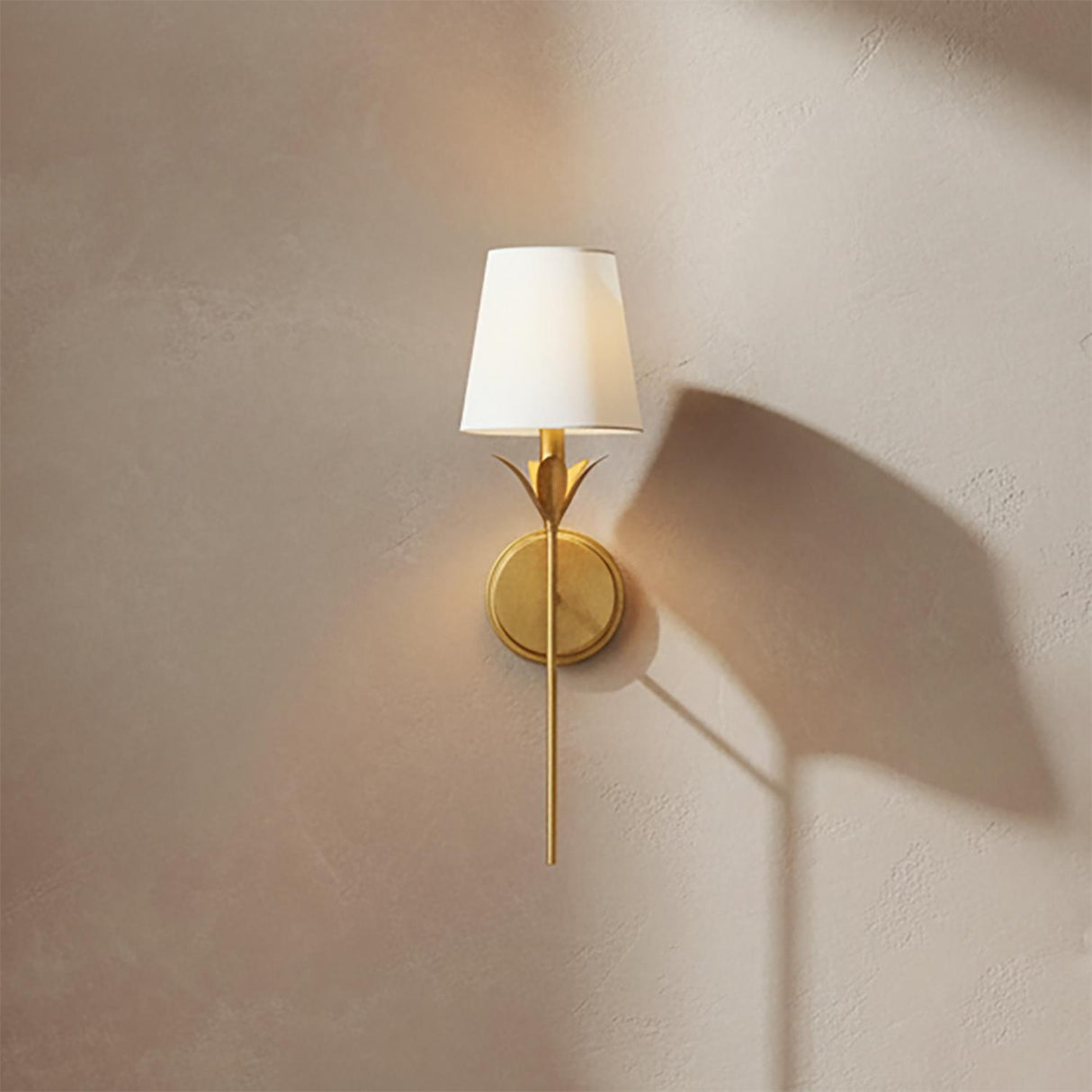 Alice Single Wall Sconce 21, Antique Gold - Gold sconce with white shade on a beige wall