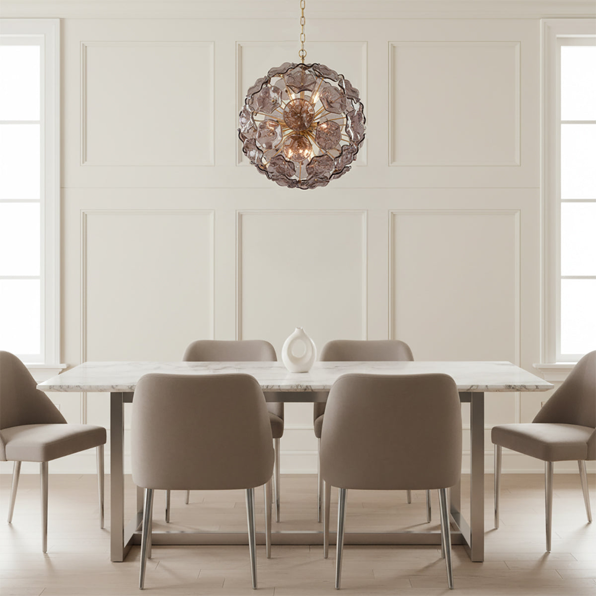 Layla Glass Pendant 22", Smoke - A dining room with a smoke glass pendant hanging above a marble table and six taupe chairs