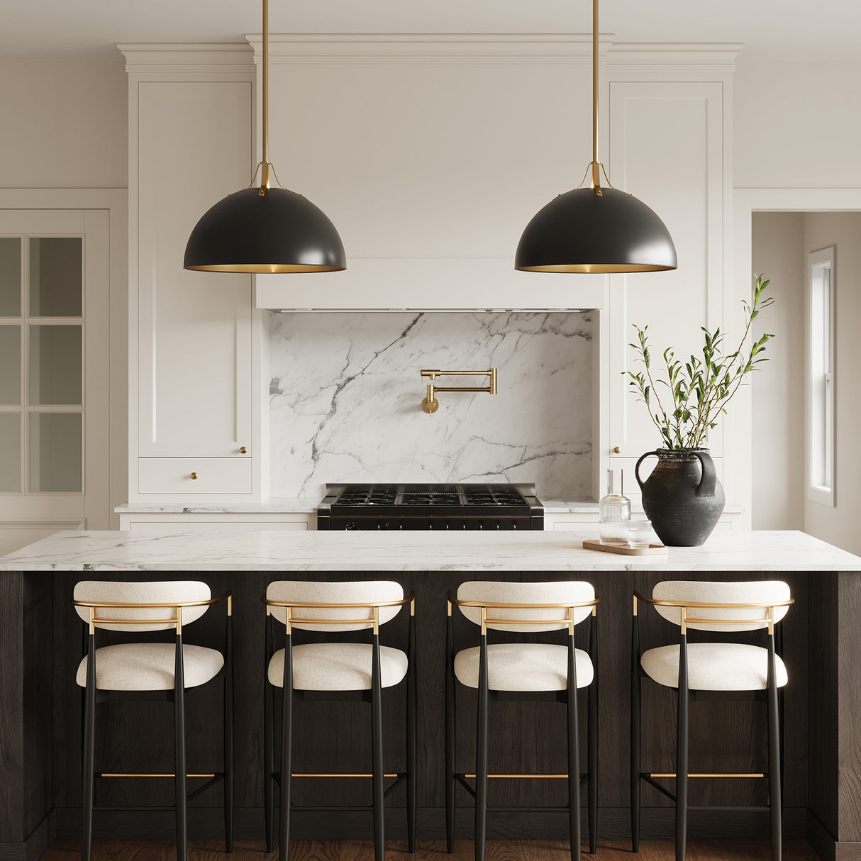 Grant 23" diameter metal pendants black and brass finish shown above an island with black and gold Arhaus style bar stools