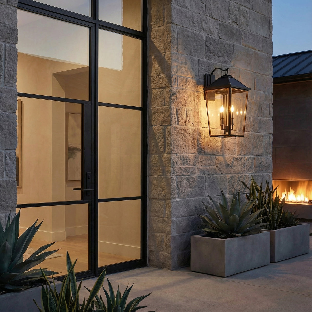 Ellington Outdoor Wall Light, Extra Large 30" Black geometric Outdoor Wall in a Modern Outdoor with a stone wall and concrete planters.