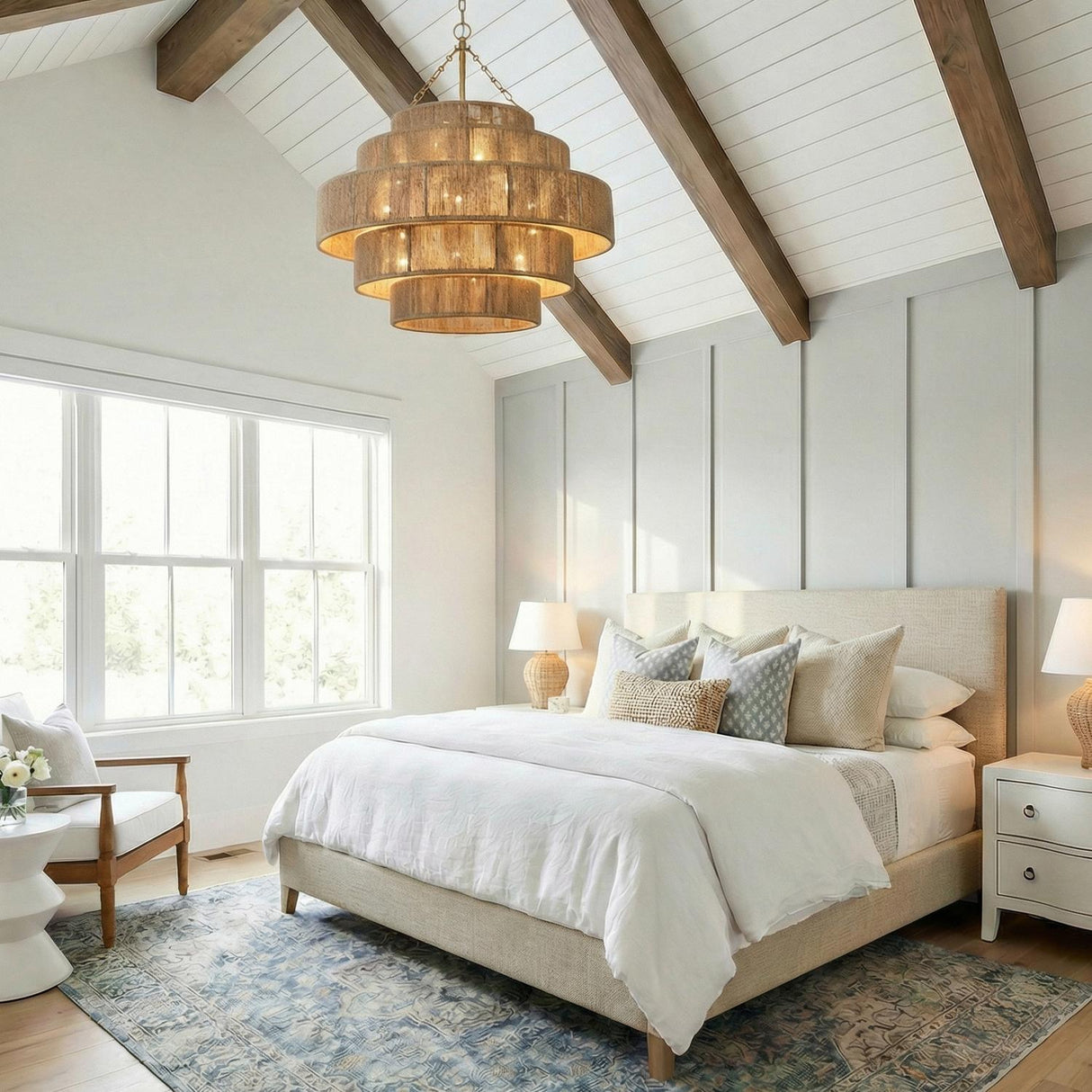 Sorelle 20 Light Chandelier 32", Jute and Soft Brass woven Chandelier in a Modern Farmhouse Bedroom with a linen bed and wood beams.