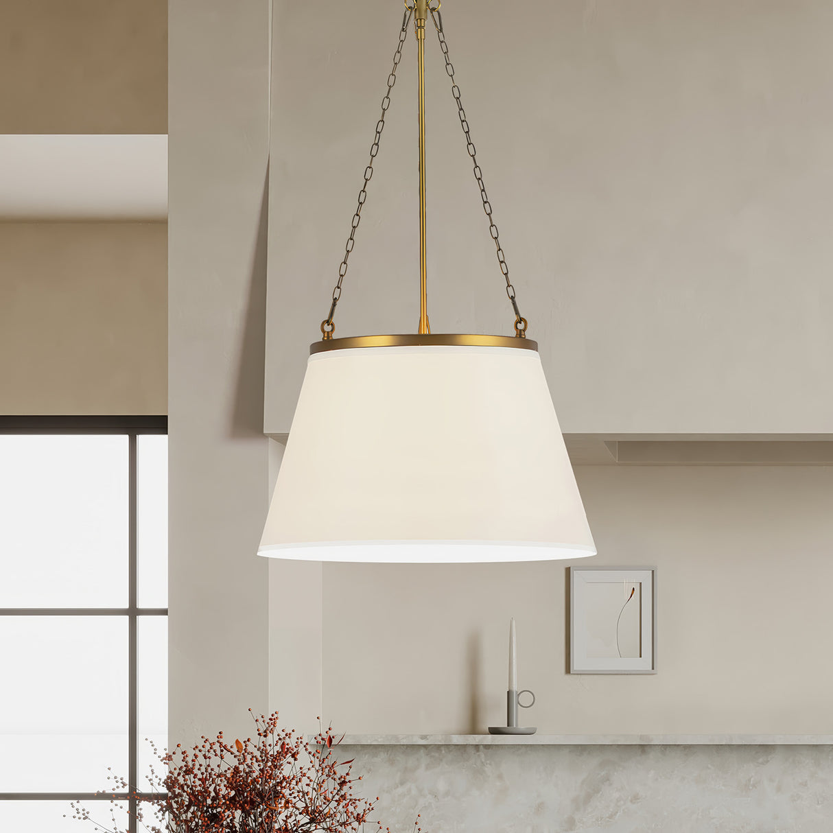 Adrian 18" wide Pendant light, Antique Brass finish with white fabric shade, is shown in an organic-modern styled kitchen.