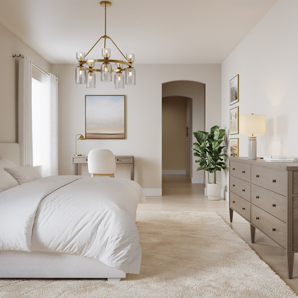 Elle Chandelier, Brushed Brass and Clear Glass, shown in a bright transitional contemporary bedroom.