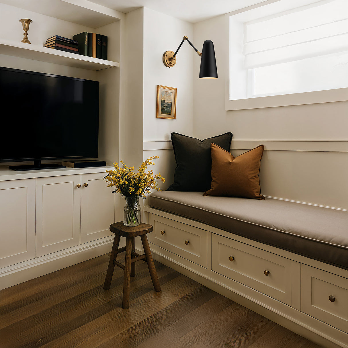 Matte Black and Brass Roy Articulating Arm Wall Sconce in a cozy den for reading, with neutral colors.