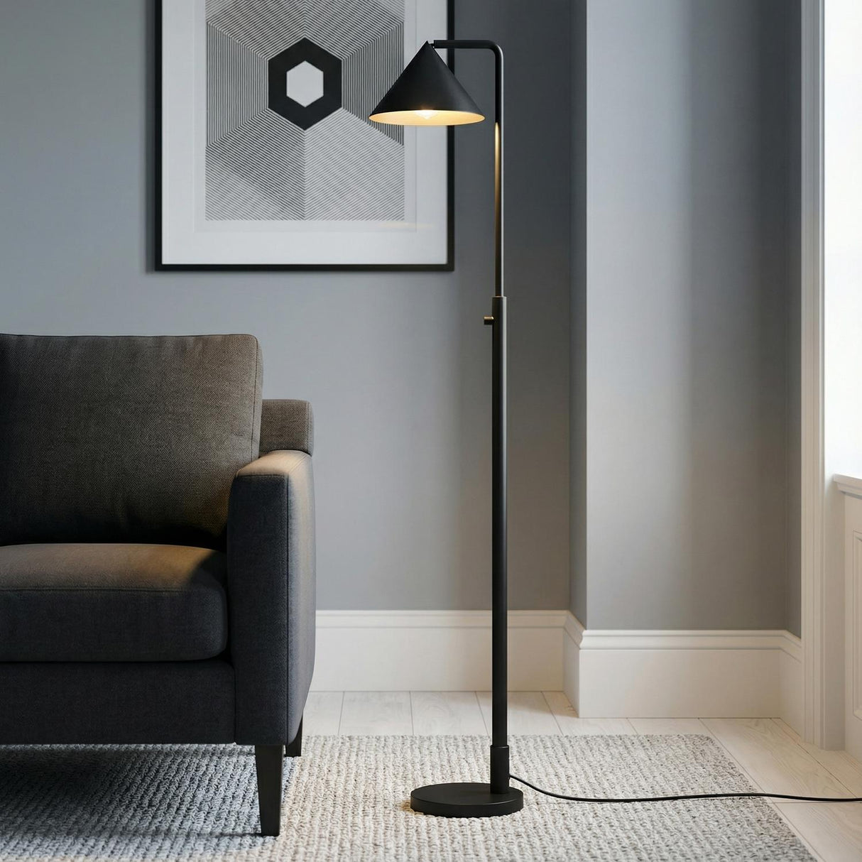 Juno Floor Lamp, Matte Black geometric Floor Lamp in a Modern Living Room with a charcoal sofa and geometric art.