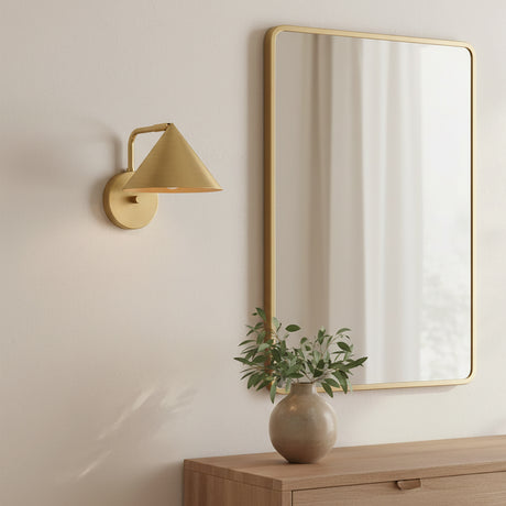 Juno Wall Sconce, Brushed Brass - Sconce and mirror over wooden dresser with vase of greenery.