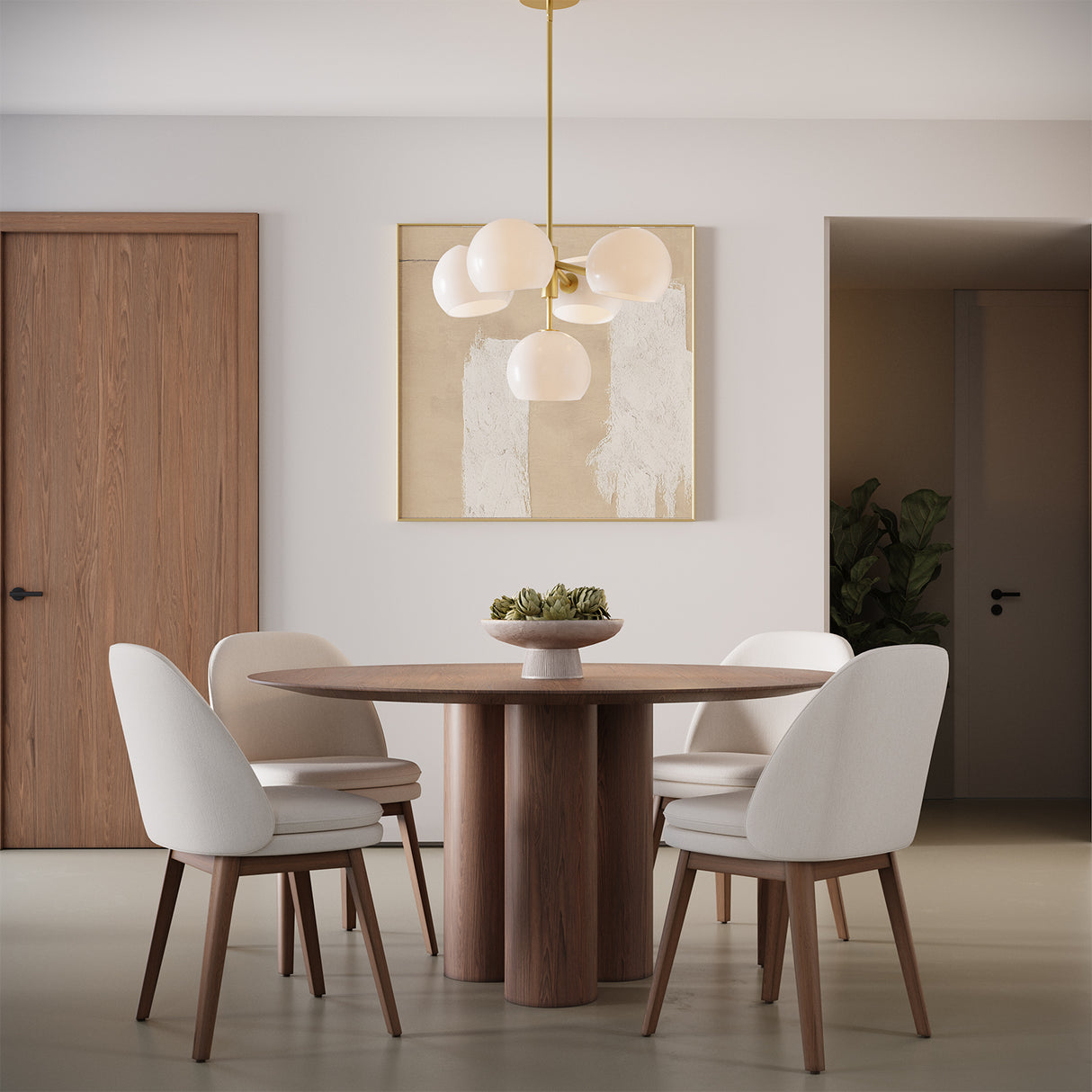 Flynn 5 Light Pendant, Brushed Brass with Opal Glass globes shown above a modern walnut dining table with four chairs.